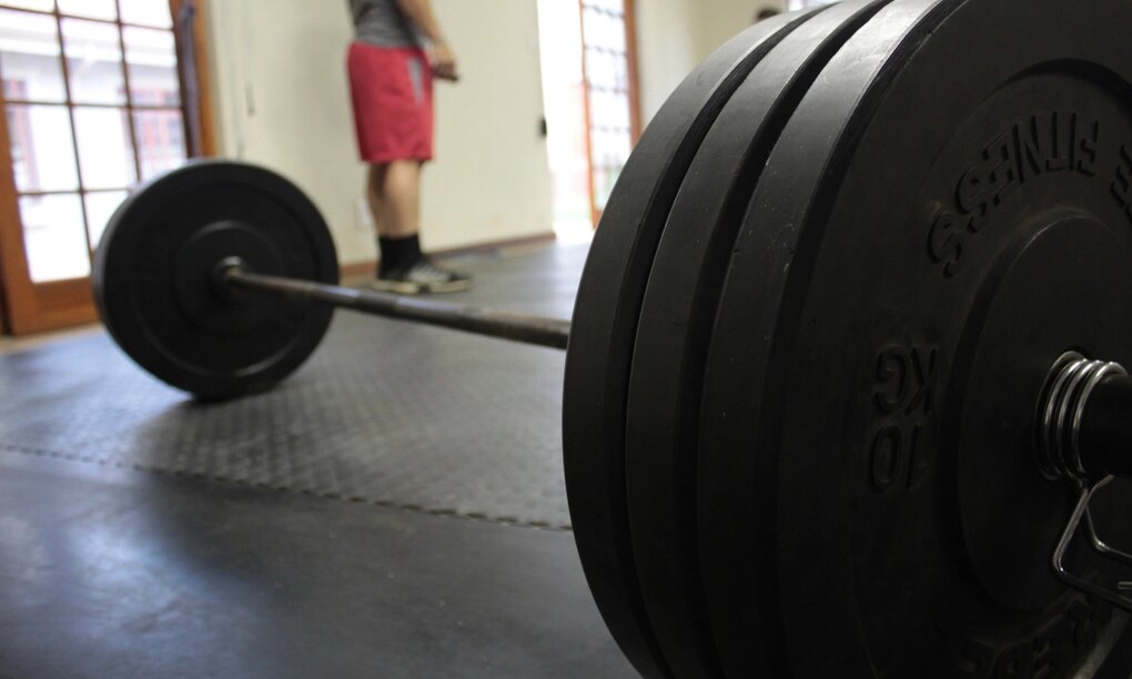 Close-up of a loaded barbell on a gym floor